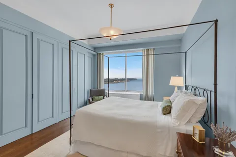 a bedroom with a bed and large window