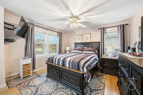 a bedroom with a bed and a chandelier