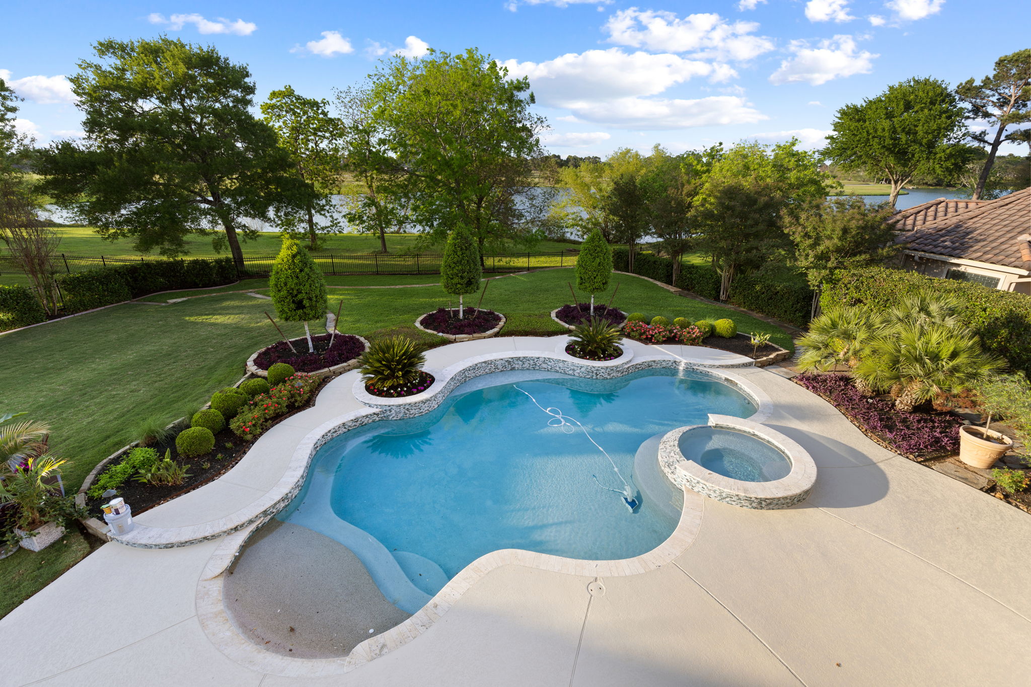 82 Manor Lake Estates Circle Spring, TX 77379 - Photo 35 of 52 a view of a swimming pool in he middle of the green field