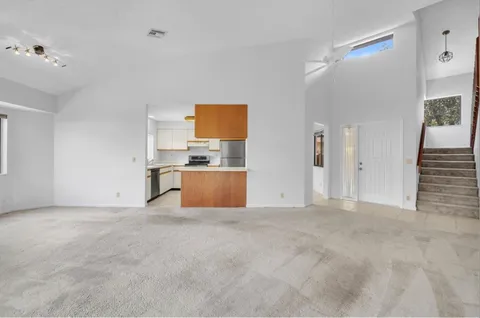 a view of kitchen with stainless steel appliances a refrigerator and a sink