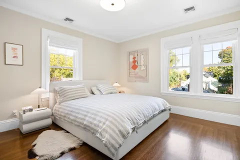 a bedroom with a bed and a large window