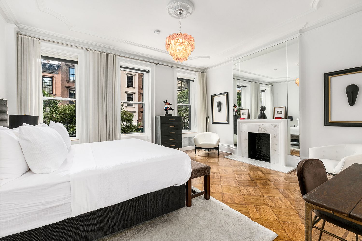 209 East 61st Street Manhattan, NY 10065 - Photo 10 of 27 a bed room with furniture and a fireplace