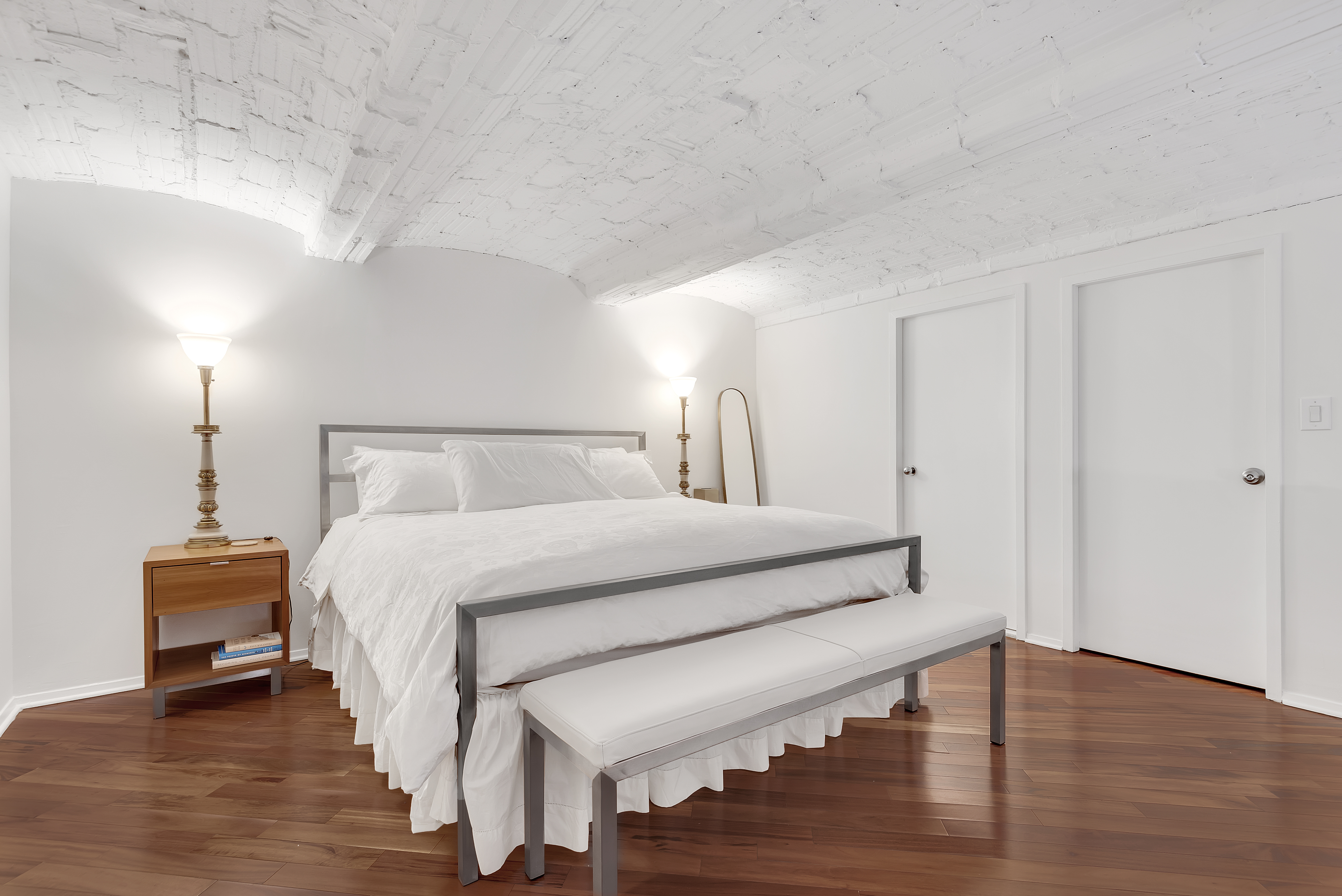 372 5th Avenue, Unit 3M Manhattan, NY 10018 - Photo 3 of 14 a bedroom with a bed and a lamp