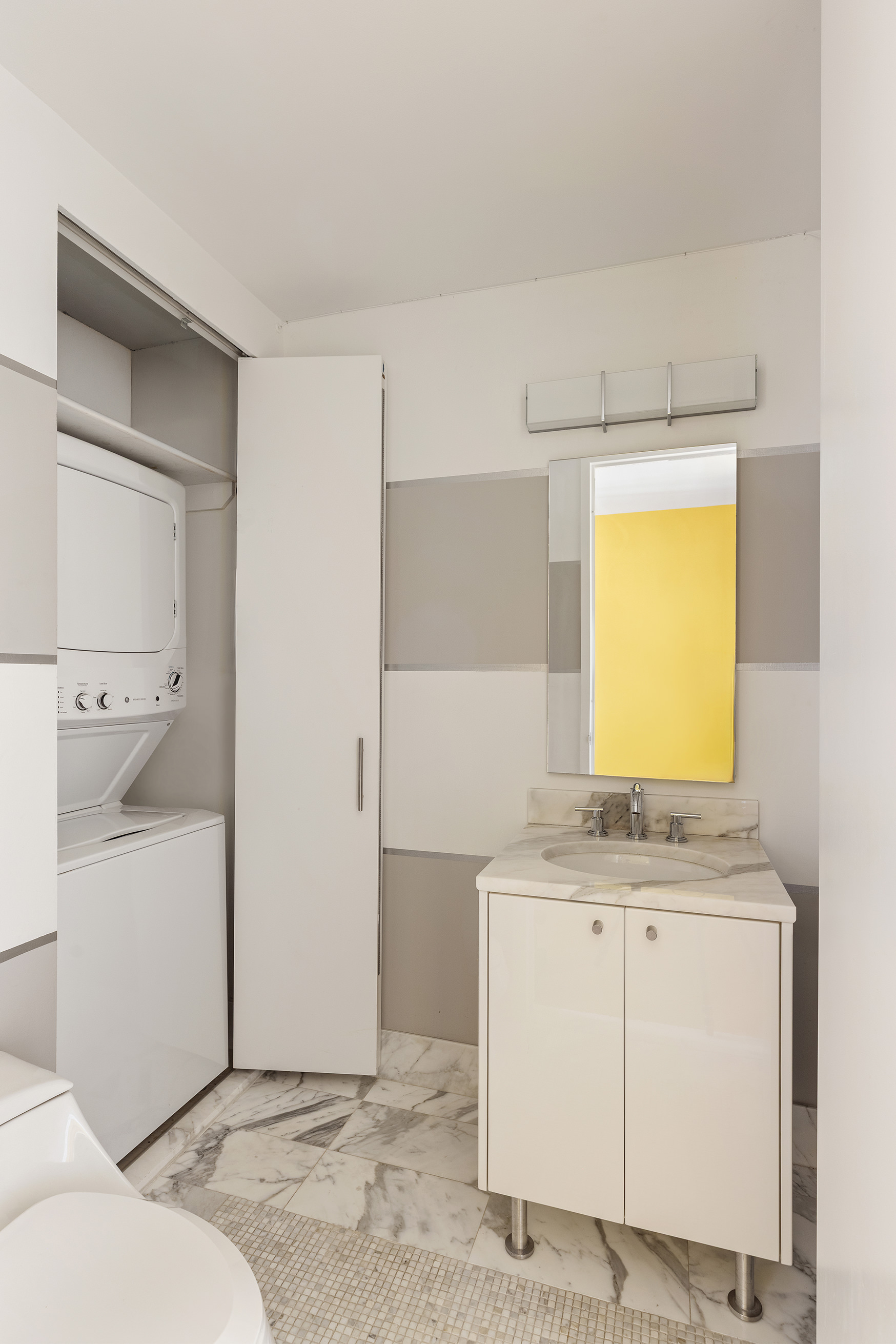 46-30 Center Boulevard, Unit 610 Queens, NY 11109 - Photo 6 of 19 a bathroom with a sink a toilet and vanity
