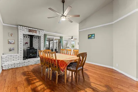 a dining room with furniture a chandelier and wooden floor