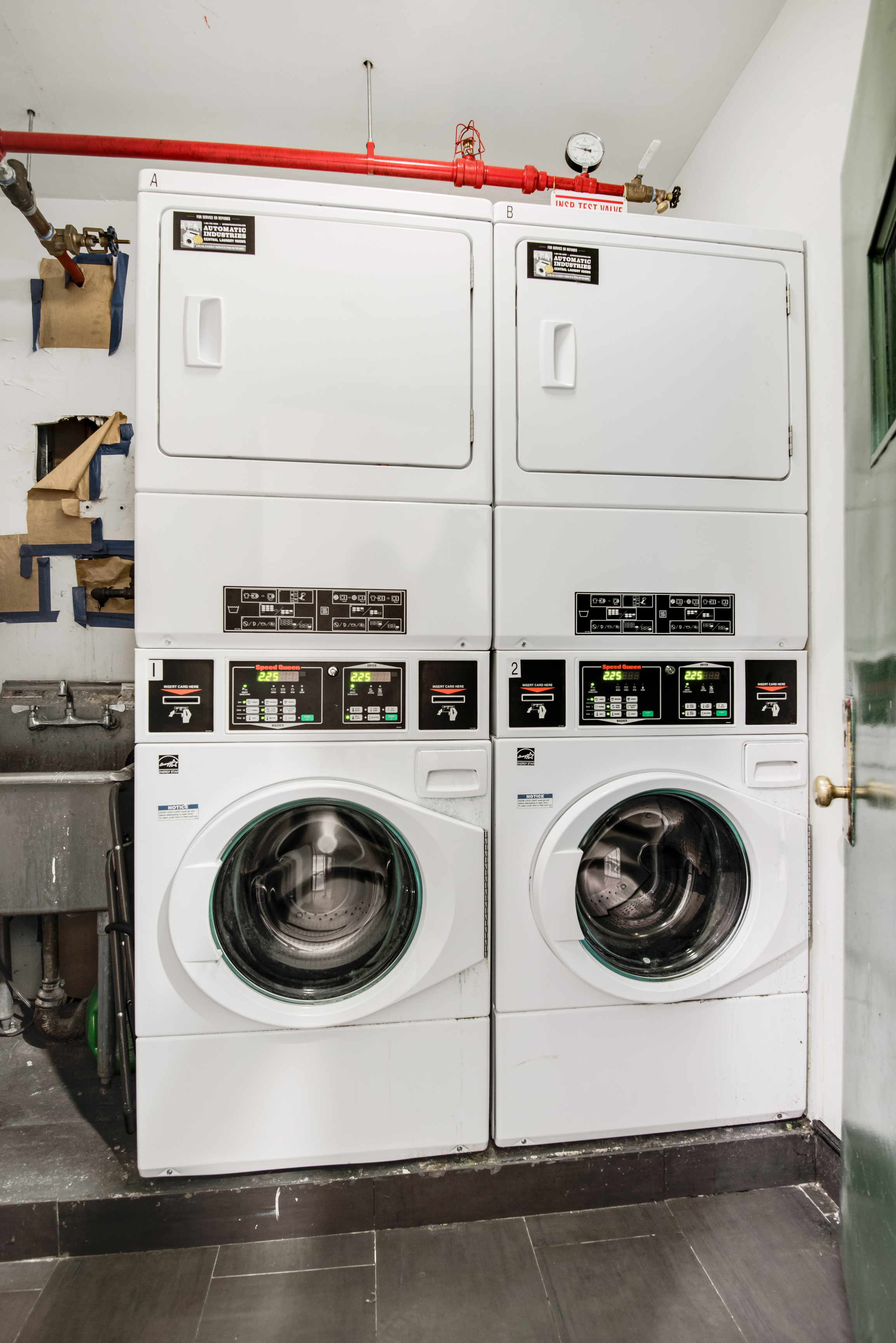 182 East 2nd Street, Unit 1E Manhattan, NY 10009 - Photo 12 of 14 a utility room with dryer and washer