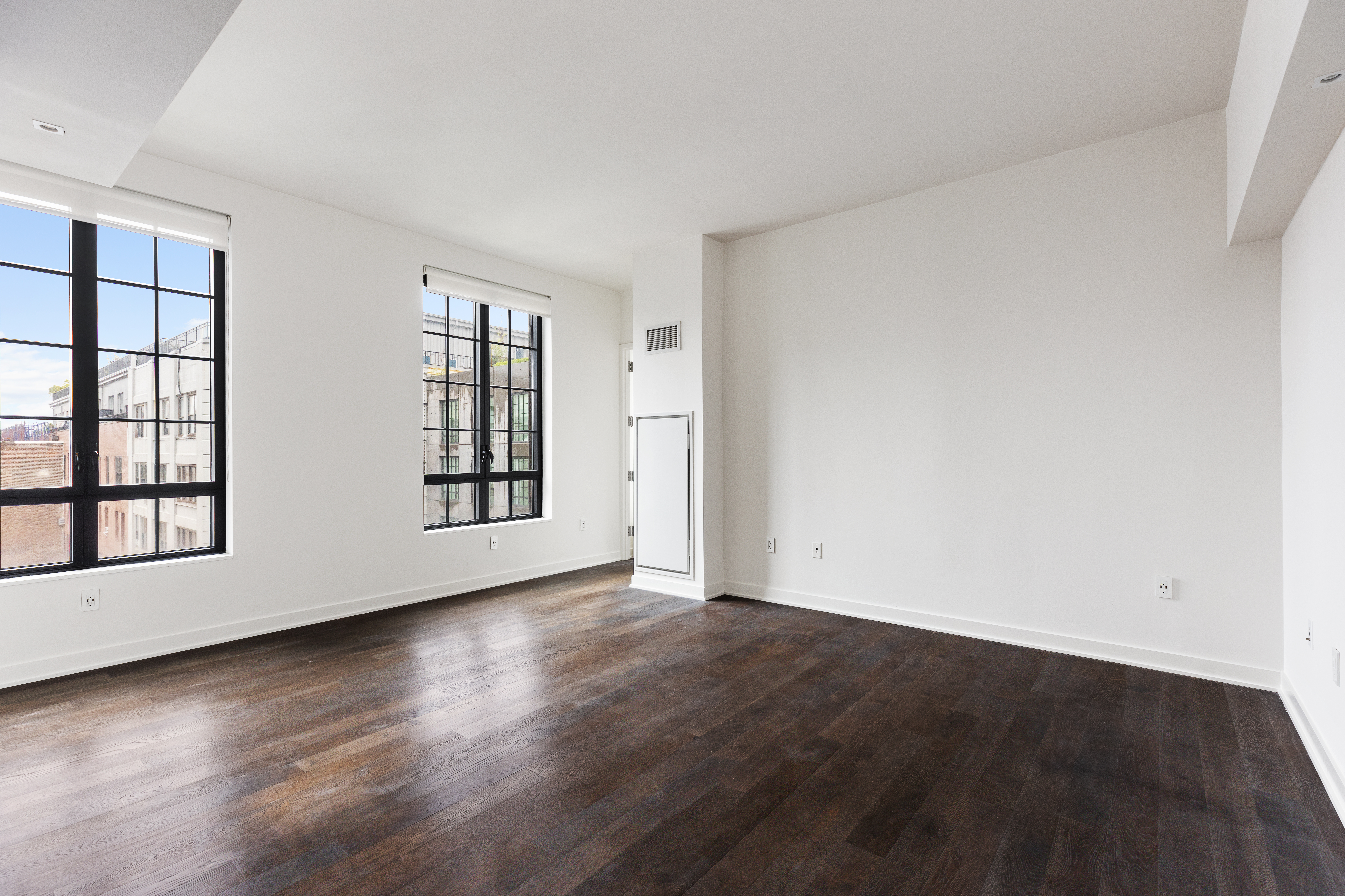 205 Water Street, Unit 7N Brooklyn, NY 11201 - Photo 2 of 11 an empty room with wooden floor and windows