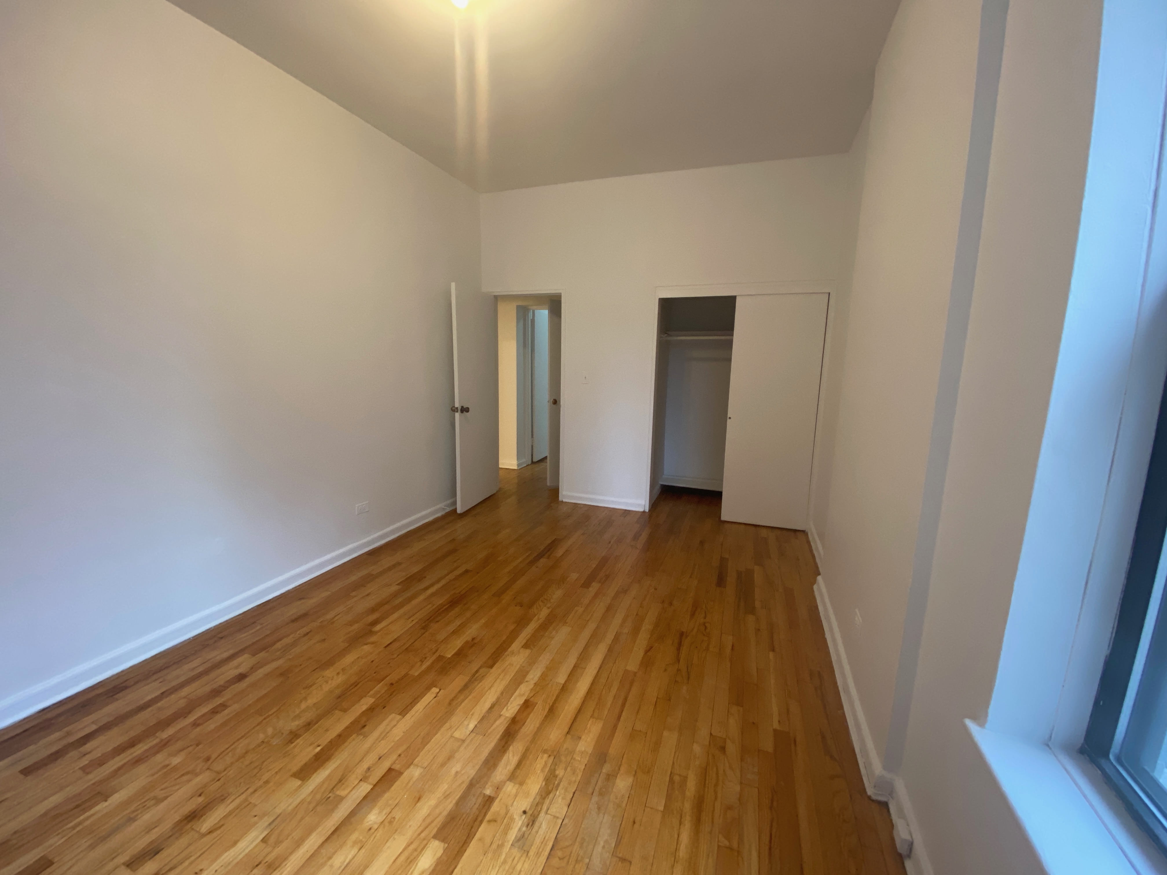 1240 Lexington Avenue, Unit 34 Manhattan, NY 10028 - Photo 8 of 11 a view of a room with wooden floor and stairs