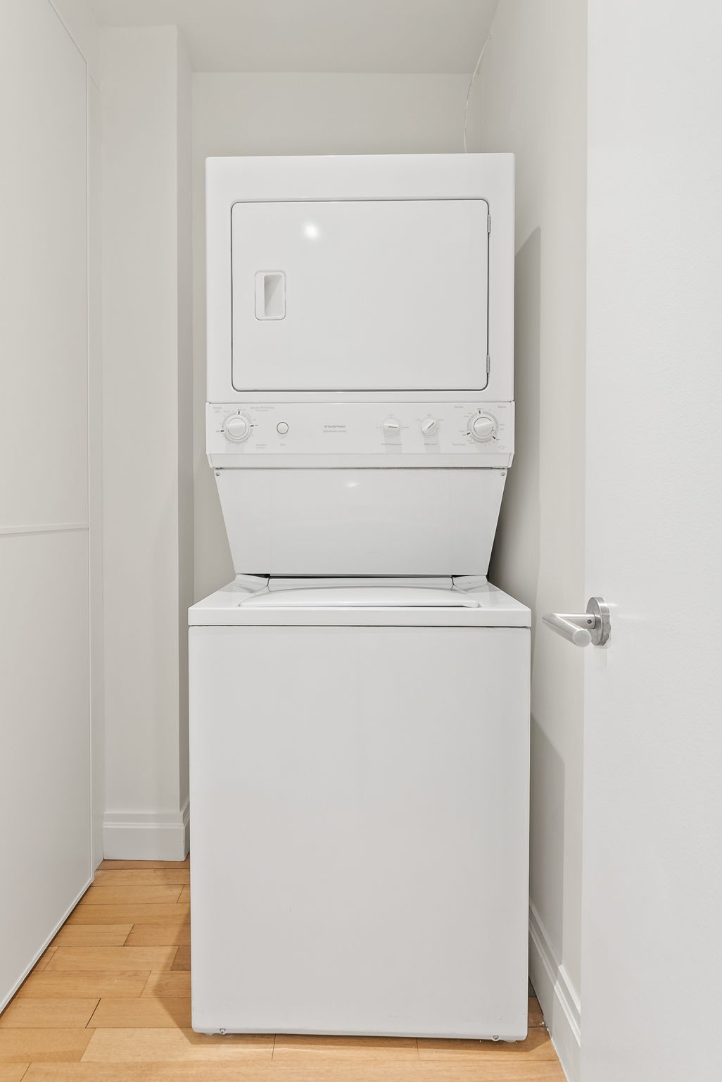 845 United Nations Plaza, Unit 63D Manhattan, NY 10017 - Photo 12 of 16 a utility room with dryer and washer