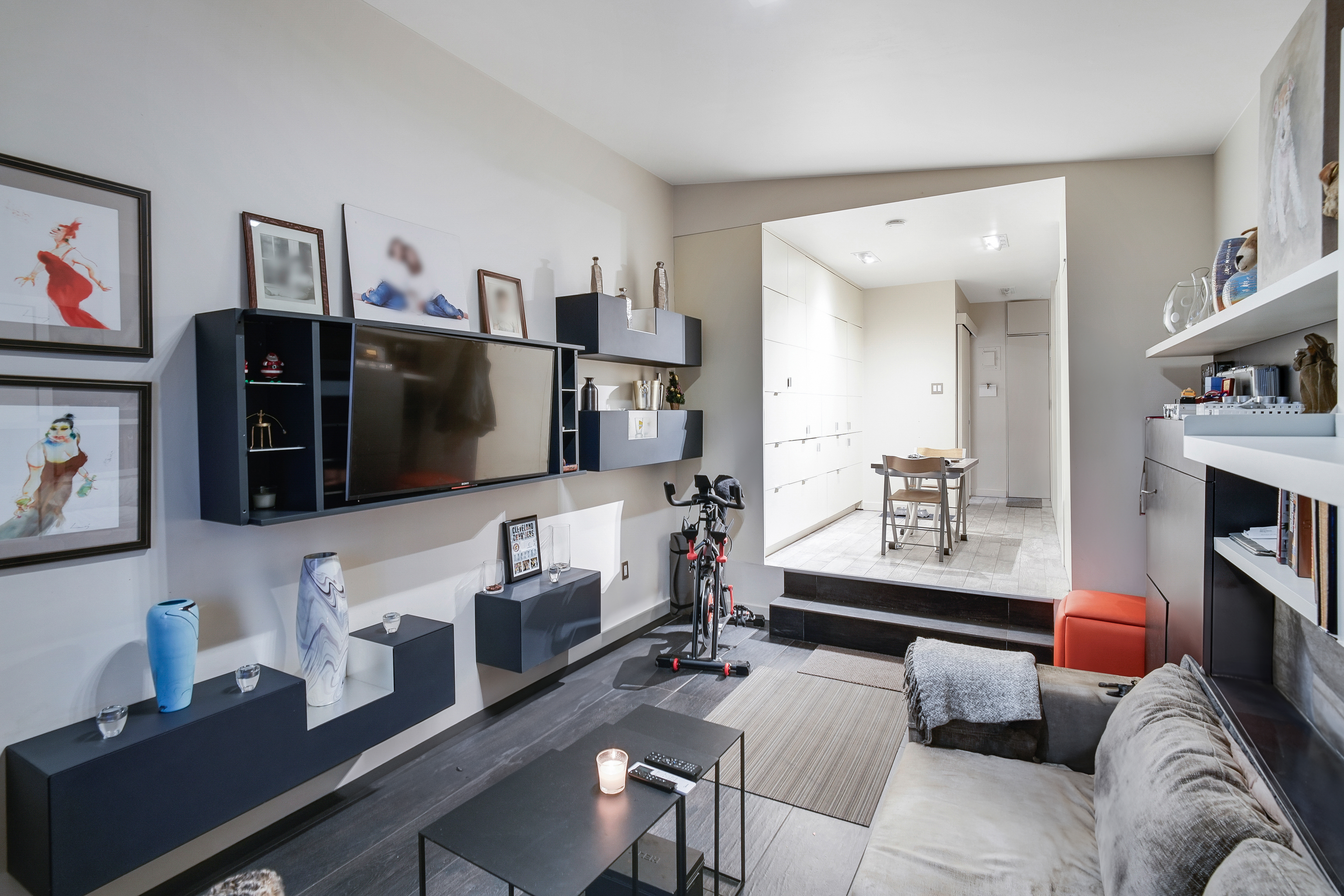 35 East 10th Street, Unit 3G Manhattan, NY 10003 - Photo 2 of 9 a living room with furniture and a flat screen tv