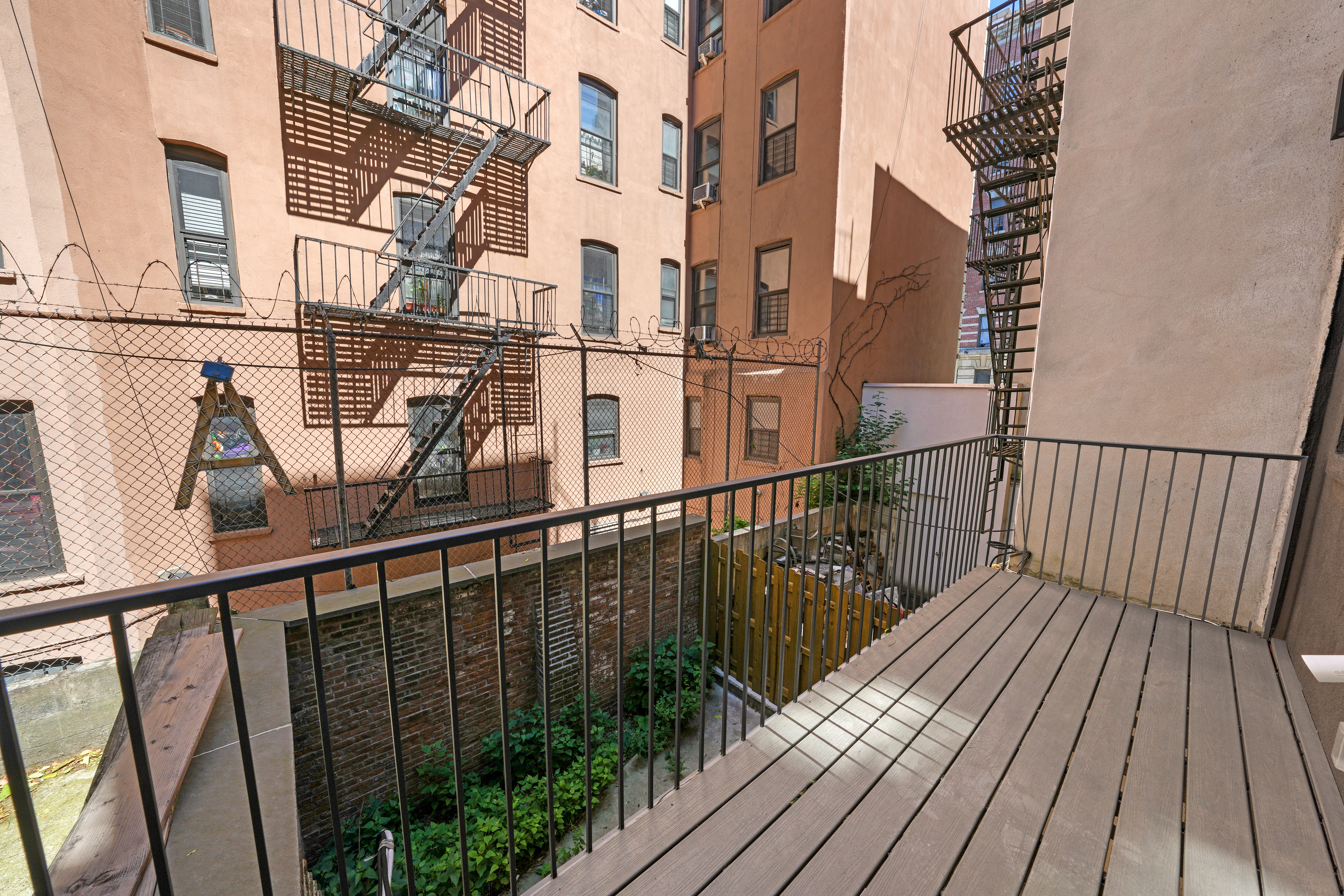 953 St Nicholas Avenue, Unit 1 Manhattan, NY 10032 - Photo 10 of 15 a view of balcony with wooden floor and fence