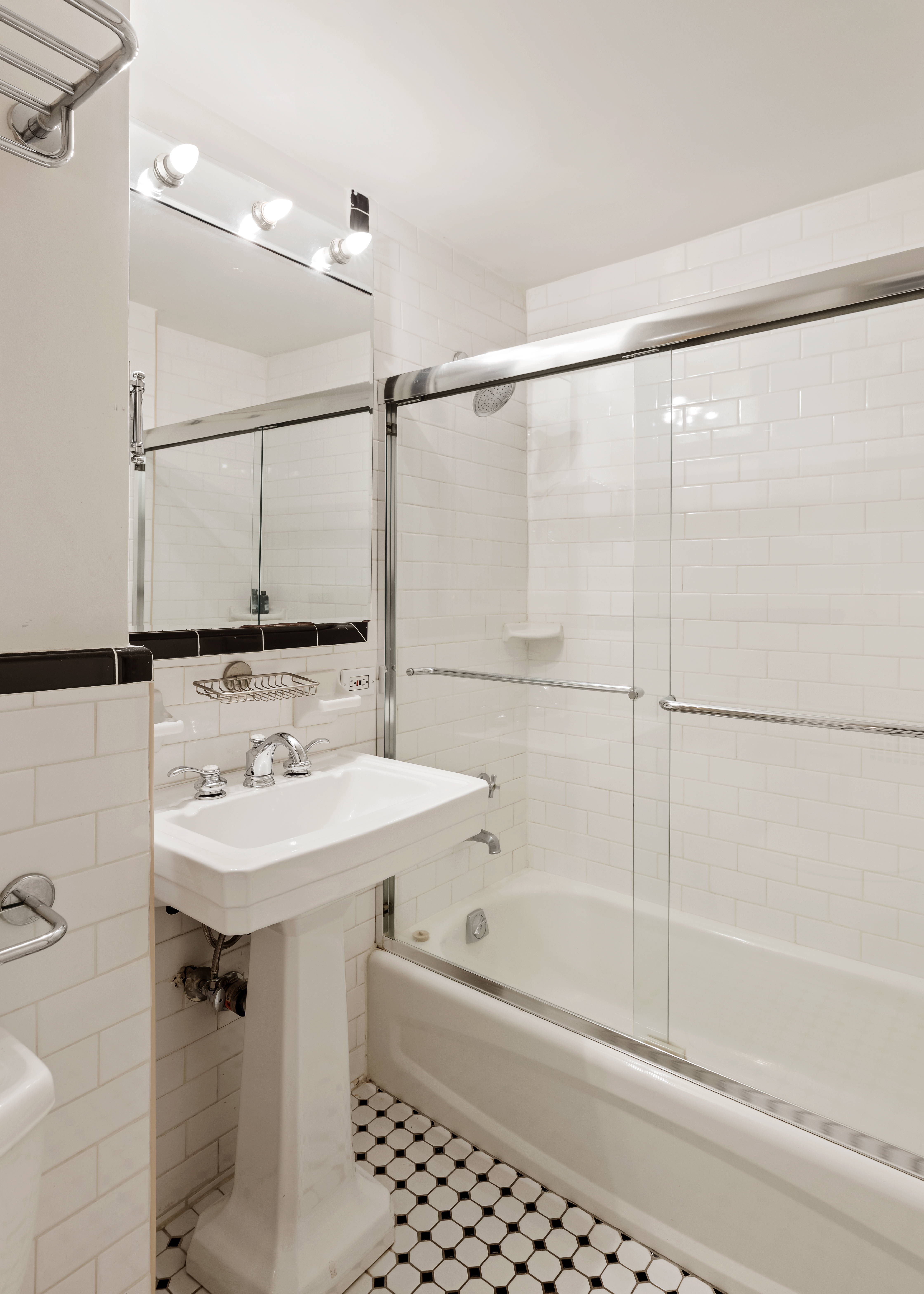 140 Cabrini Boulevard, Unit 18/19 Manhattan, NY 10033 - Photo 15 of 21 a bathroom with a sink mirror and a bathtub