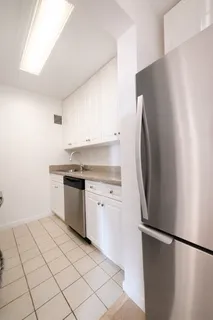 a kitchen with a refrigerator and a sink