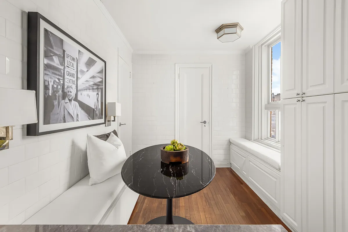 180 East 79th Street, Unit 14B Manhattan, NY 10075 - Photo 12 of 18 a living room with furniture and a potted plant
