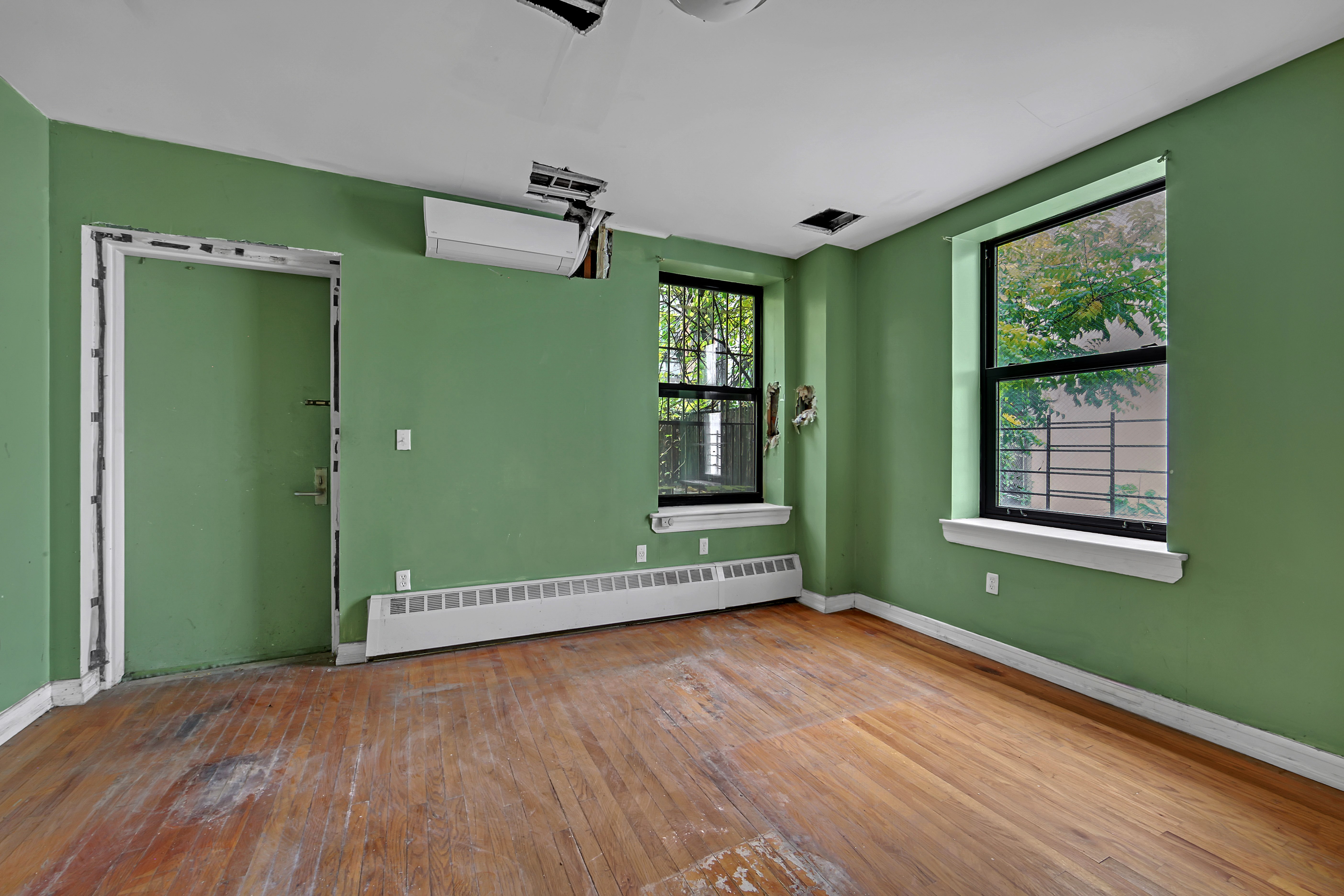 430 Lenox Avenue, Unit 1 Manhattan, NY 10037 - Photo 3 of 14 a view of room with window and wooden floor