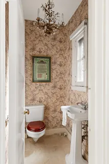 a bathroom with a toilet sink and mirror