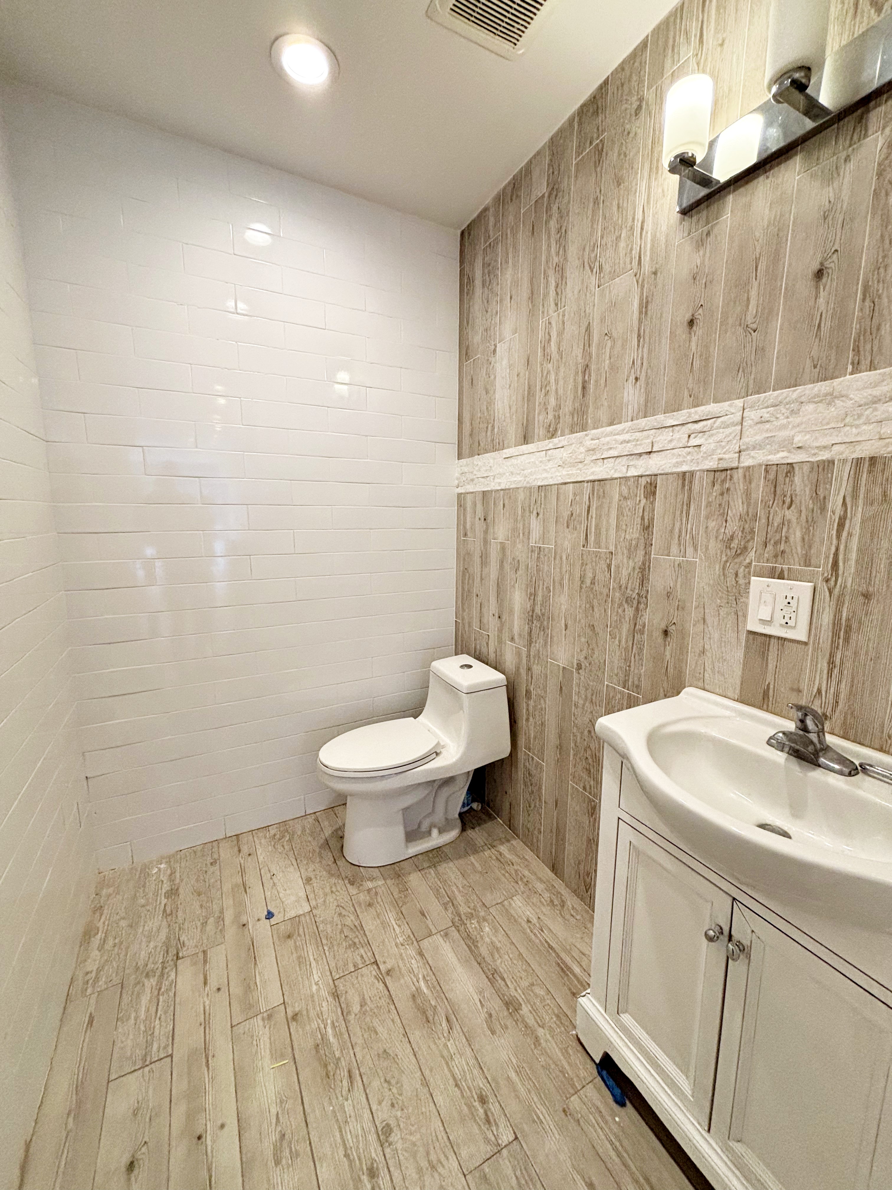 385 Nostrand Avenue, Unit Undisclosed Brooklyn, NY 11216 - Photo 8 of 27 a bathroom with a sink a toilet and a mirror