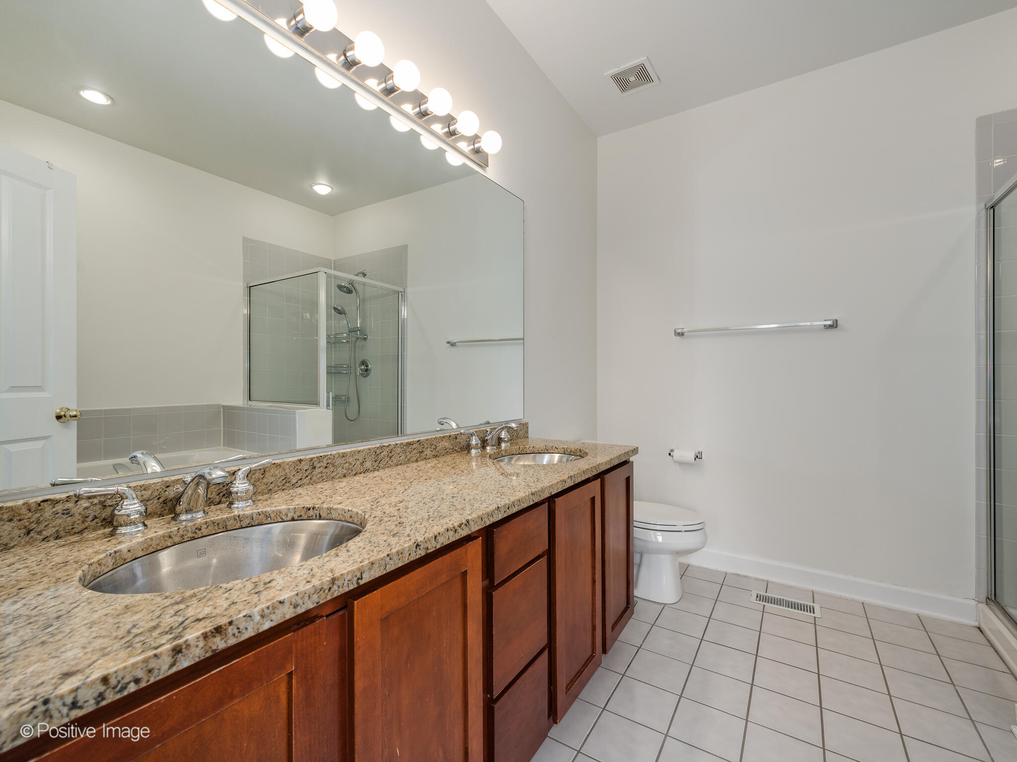 855 North May Street, Unit G Chicago, IL 60642 - Photo 21 of 28 a bathroom with a granite countertop sink and a mirror