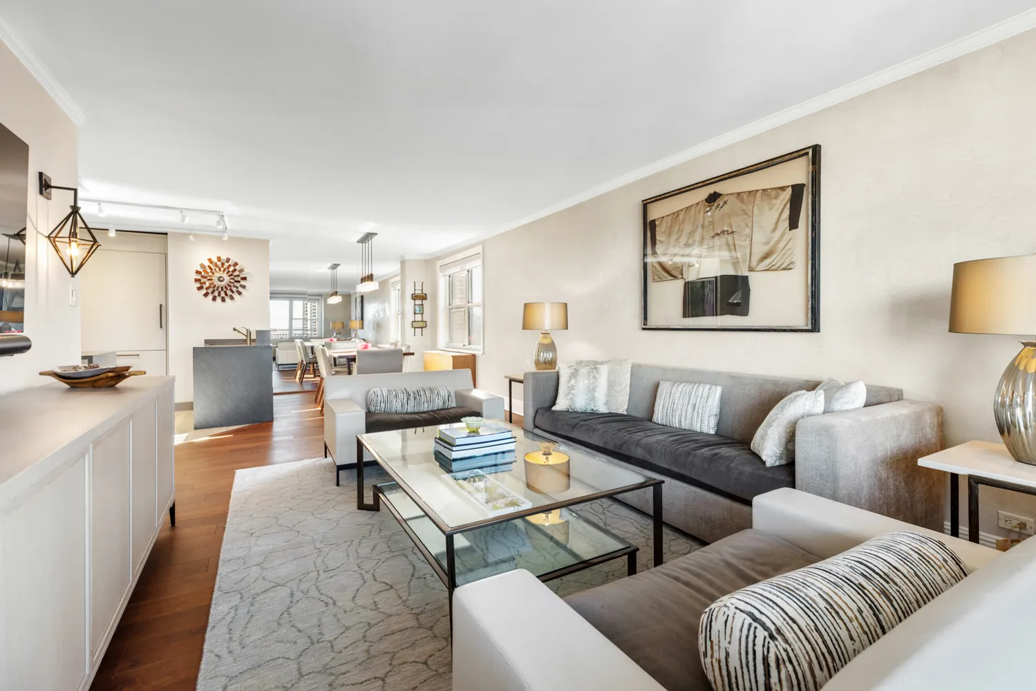 a living room with furniture kitchen view and a window