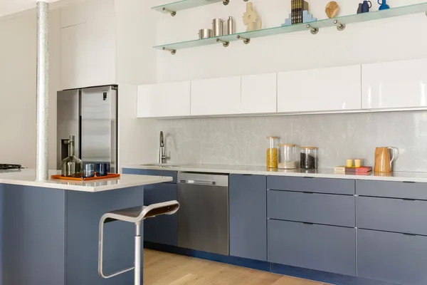 a kitchen with stainless steel appliances granite countertop a sink a stove and white cabinets
