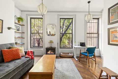a living room with furniture fireplace and a window