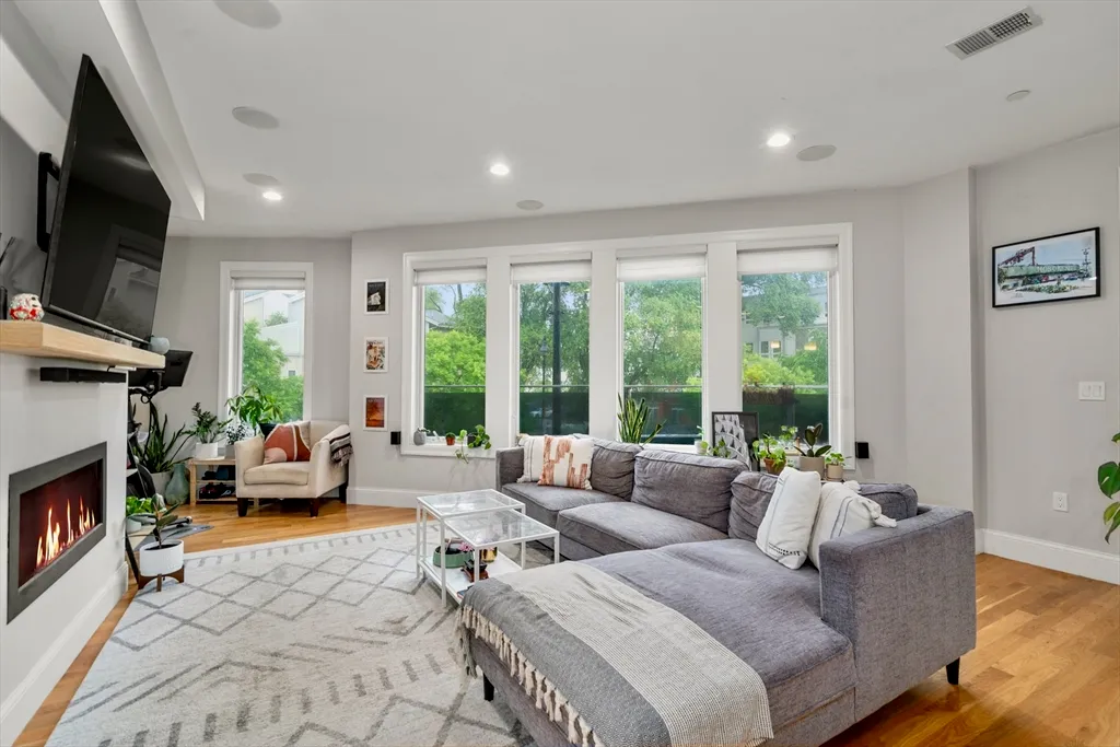 a living room with furniture flat screen tv and a fireplace