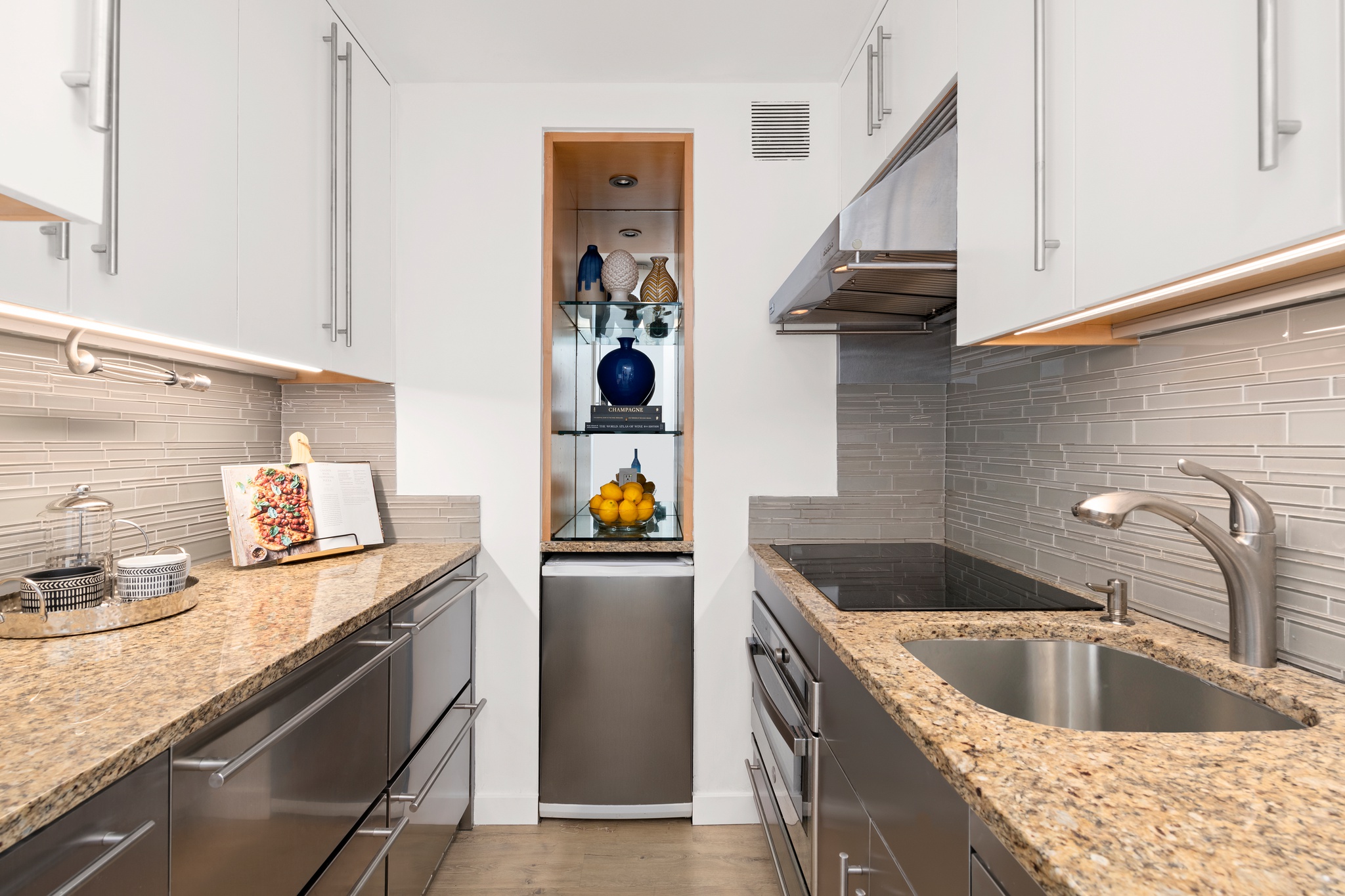 79 West 12th Street, Unit 6BC Manhattan, NY 10011 - Photo 7 of 15 a kitchen with stainless steel appliances granite countertop a sink and a stove
