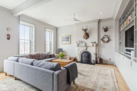 a living room with furniture and a fireplace