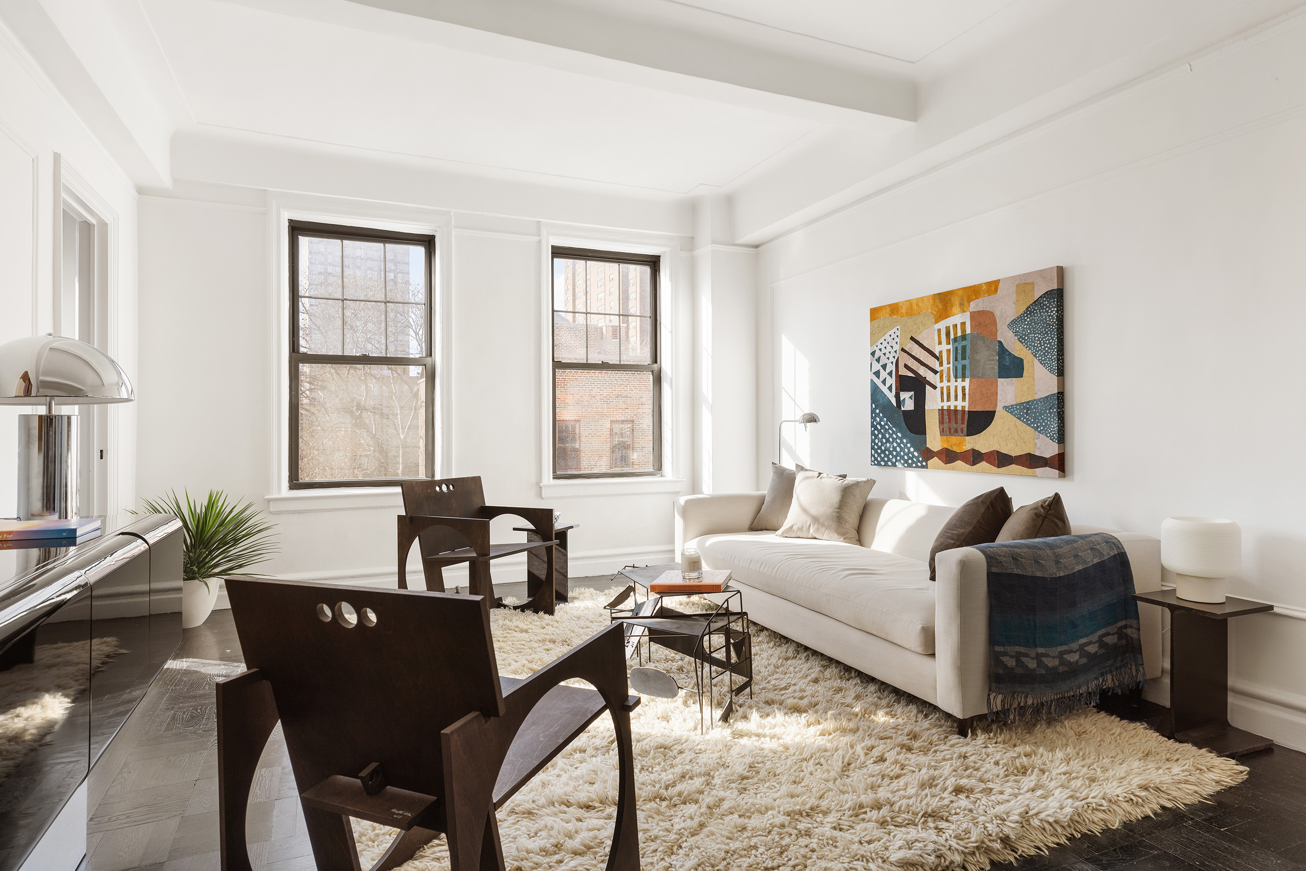 141 East 3rd Street, Unit 5H Manhattan, NY 10009 - Photo 2 of 12 a living room with furniture and windows