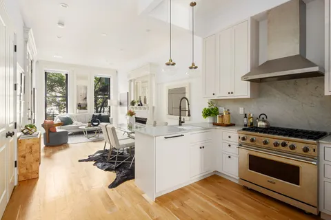 a kitchen with a stove a sink and a refrigerator