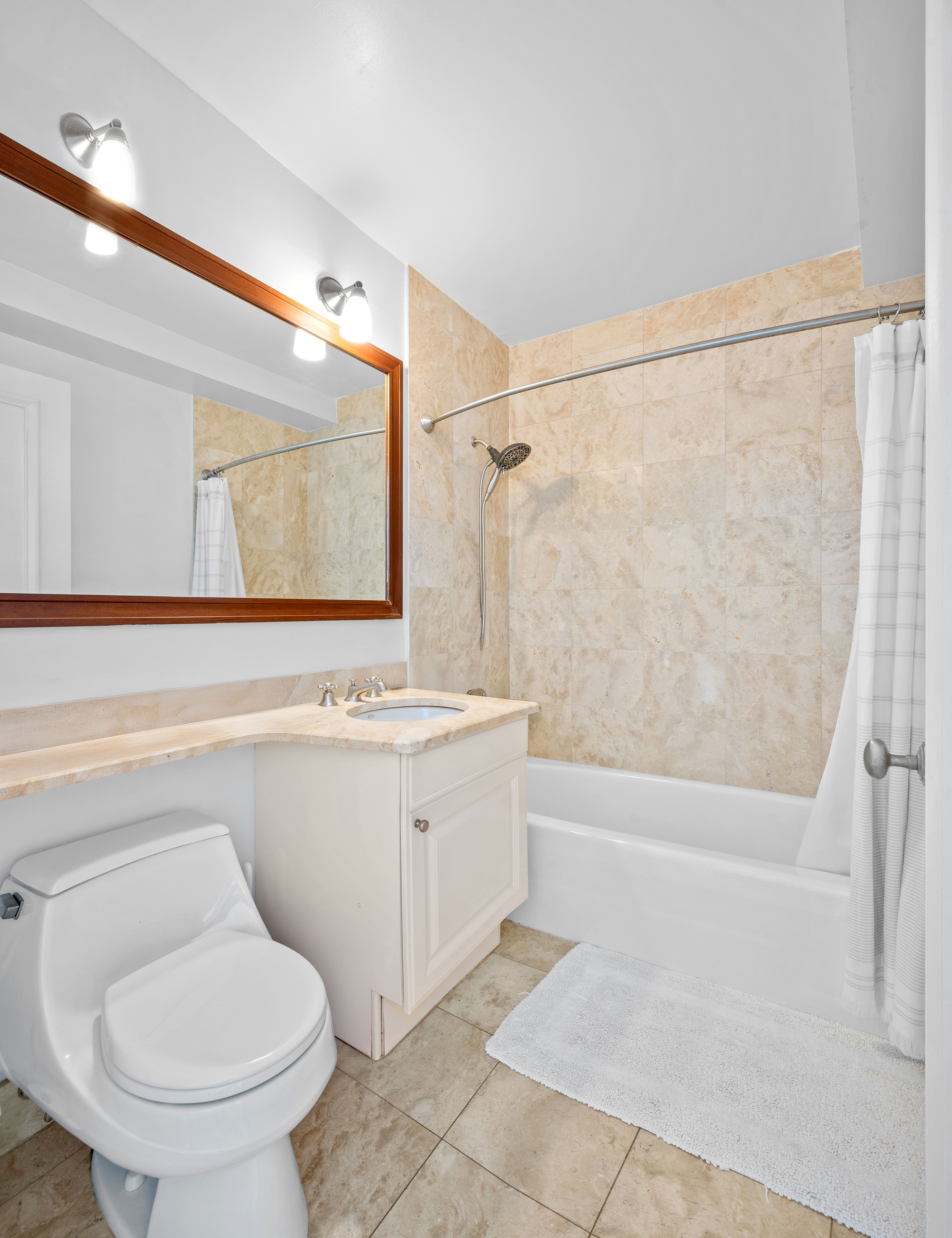 10 West Street, Unit 28C Manhattan, NY 10004 - Photo 9 of 12 a bathroom with a sink toilet and shower
