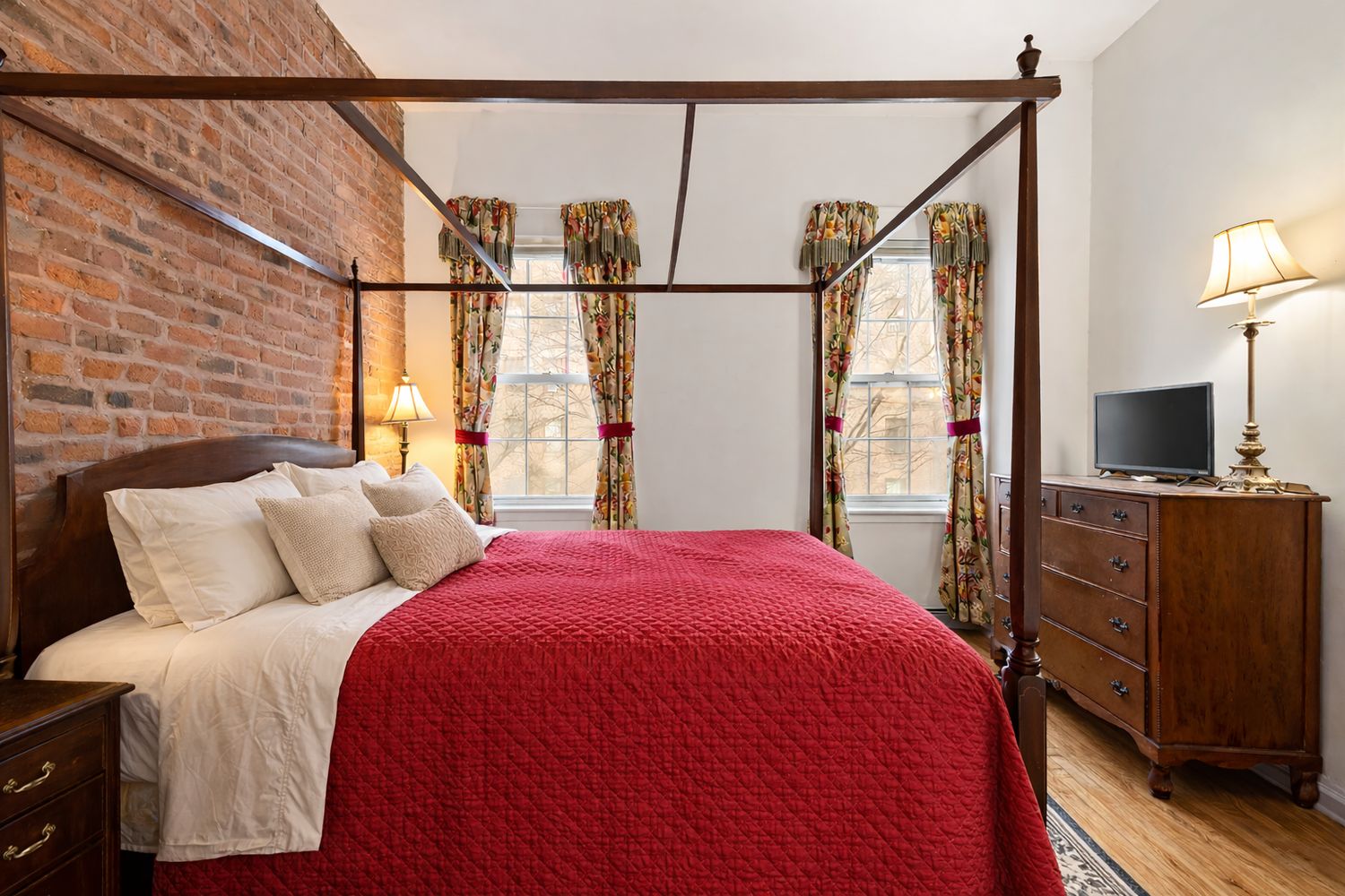 449 1/2 Hudson Street Manhattan, NY 10014 - Photo 11 of 19 a bedroom with a bed and a flat tv screen on dresser