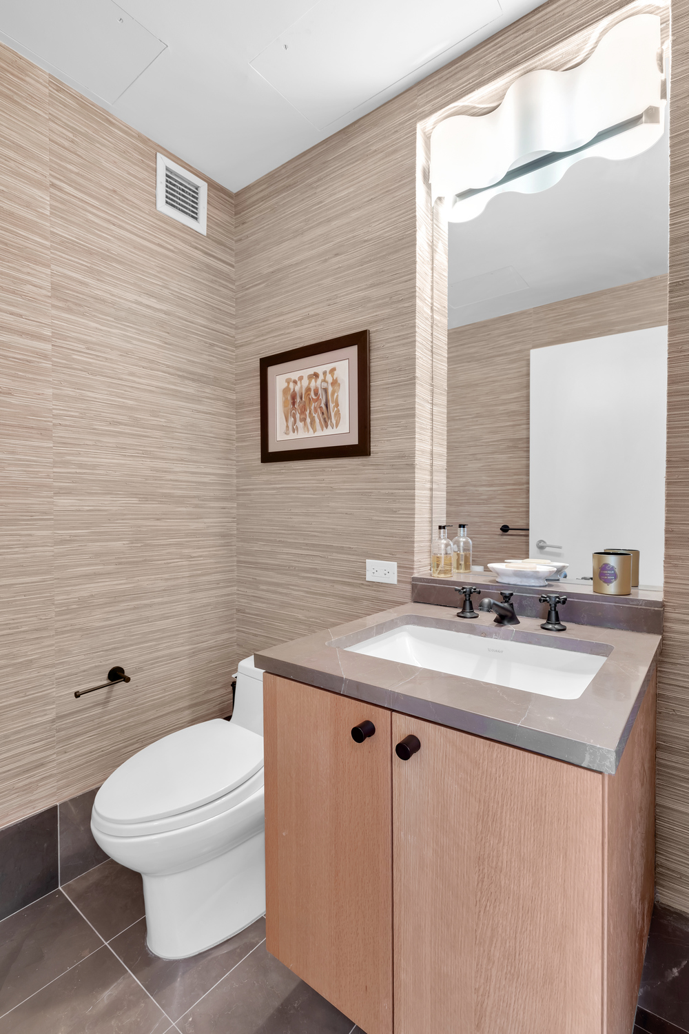 207 East 57th Street, Unit 25B Manhattan, NY 10022 - Photo 14 of 19 a bathroom with a toilet a sink a mirror and a shower