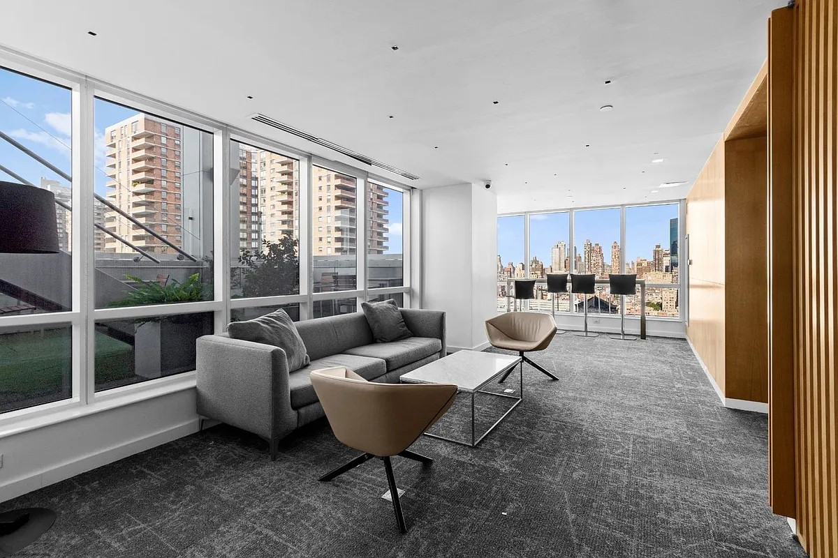 350 West 42nd Street, Unit 12C Manhattan, NY 10036 - Photo 15 of 21 a living room with furniture and a large window