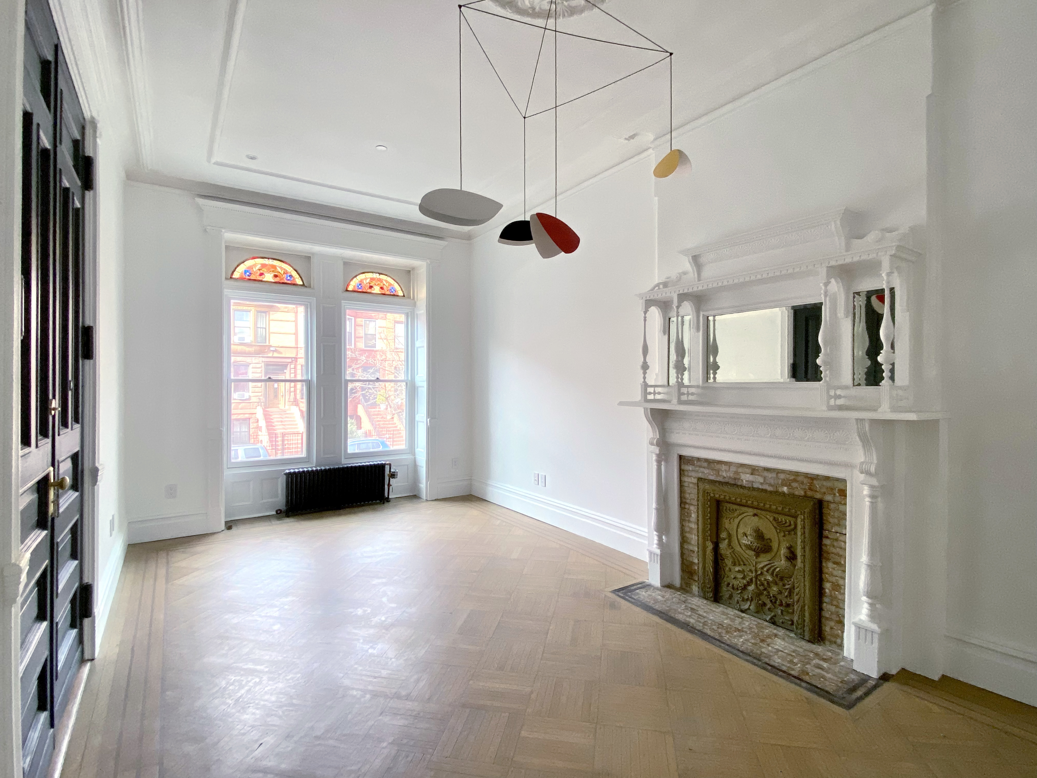 1420 Pacific Street, Unit 1 Brooklyn, NY 11216 - Photo 6 of 30 a view of an empty room with a fireplace and a window