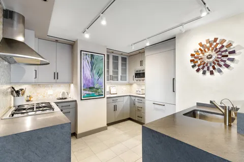a kitchen with a sink stove and refrigerator
