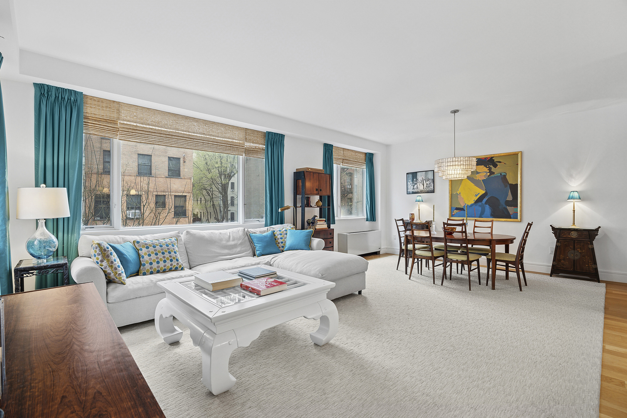 331 East 8th Street, Unit 2 Manhattan, NY 10009 - Photo 4 of 12 a living room with furniture and a large window