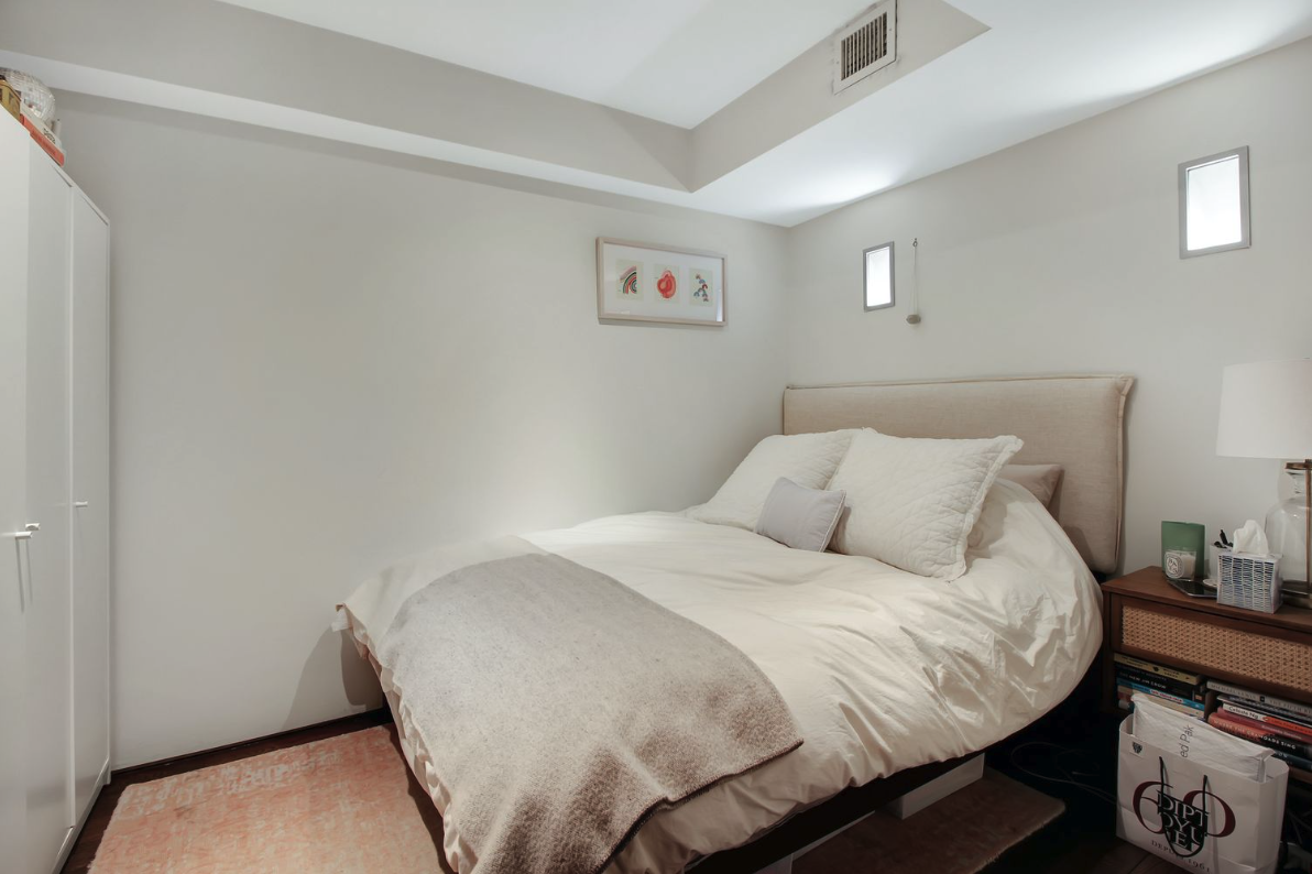 405 Broadway, Unit 4 Manhattan, NY 10013 - Photo 18 of 19 a bedroom with a bed and wooden floor