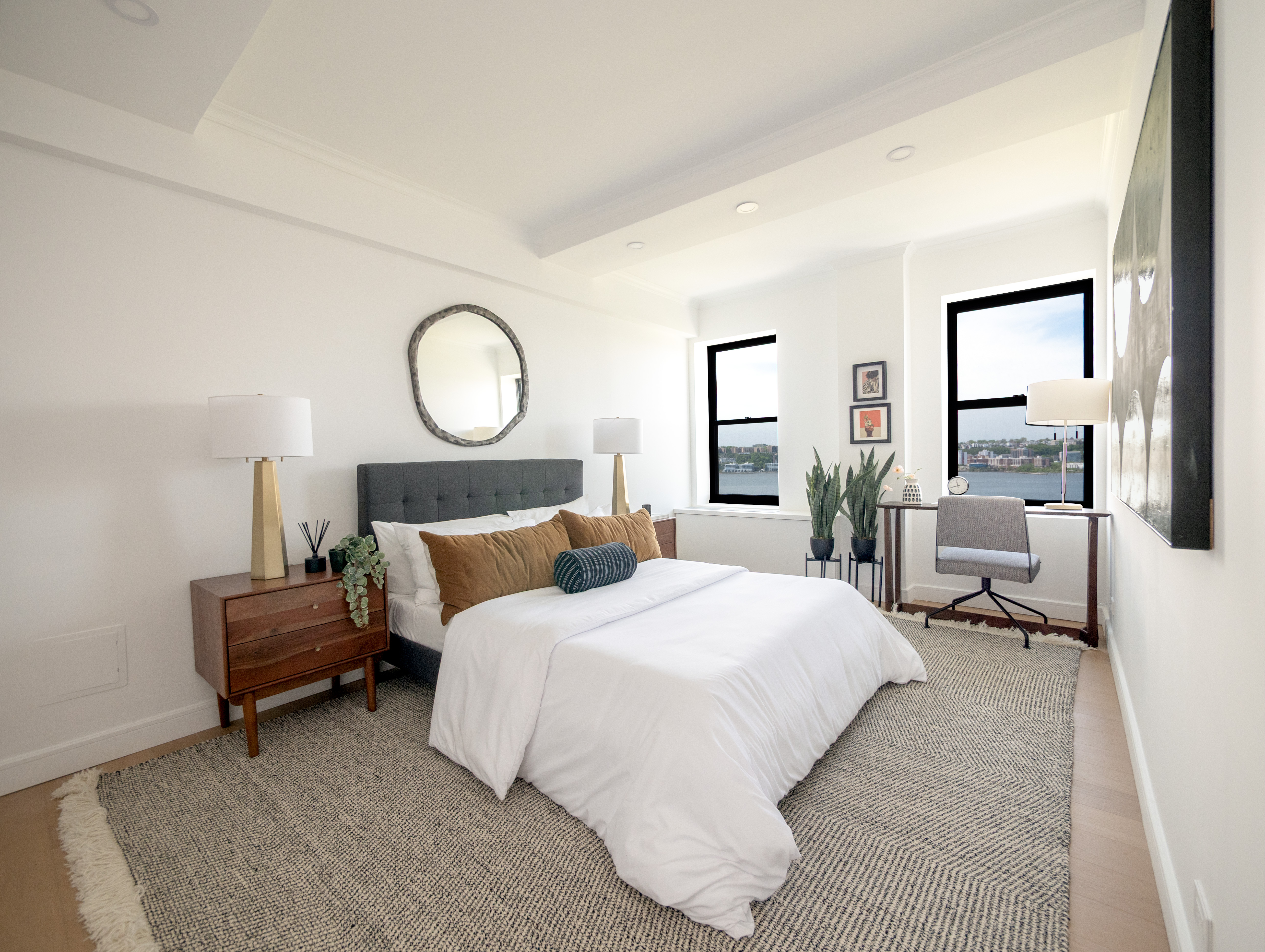 230 Riverside Drive, Unit 14AC Manhattan, NY 10025 - Photo 17 of 30 a bedroom with bed and a large mirror with window