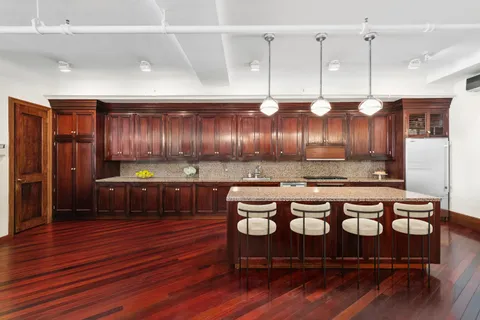 a kitchen with a cabinets and wooden floor