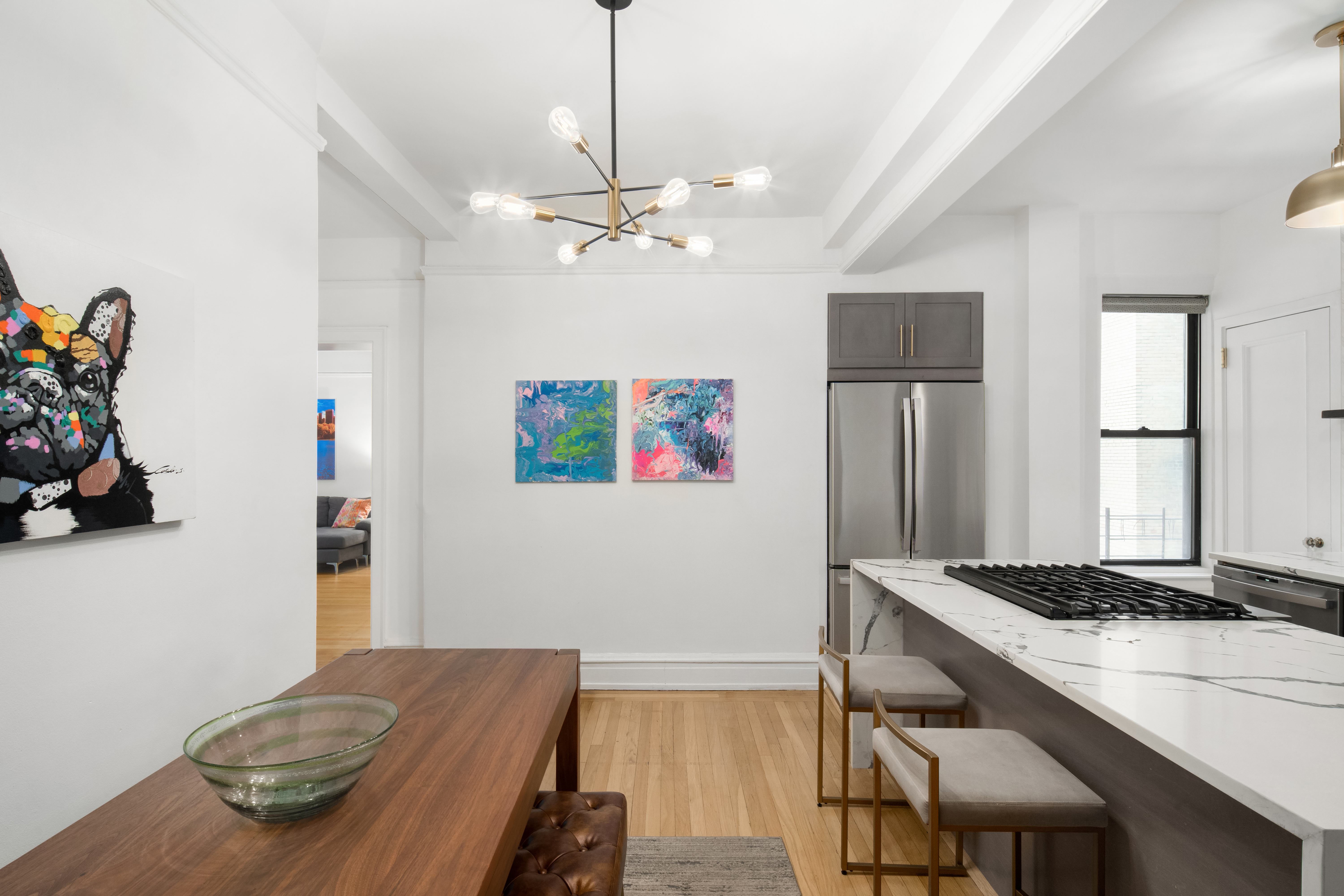 150 West 55th Street, Unit 5D Manhattan, NY 10019 - Photo 4 of 12 a living room with kitchen island furniture and a table