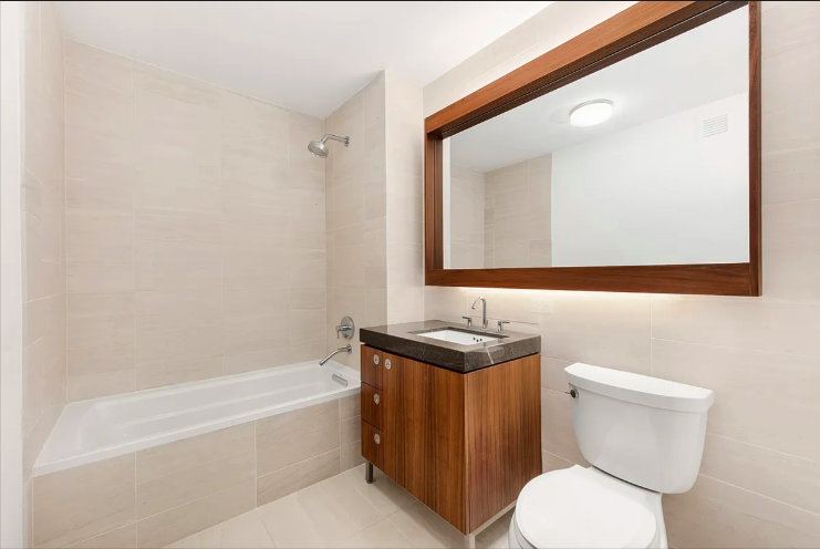 57 Reade Street, Unit 5B Manhattan, NY 10007 - Photo 4 of 5 a bathroom with a toilet a sink and bathtub