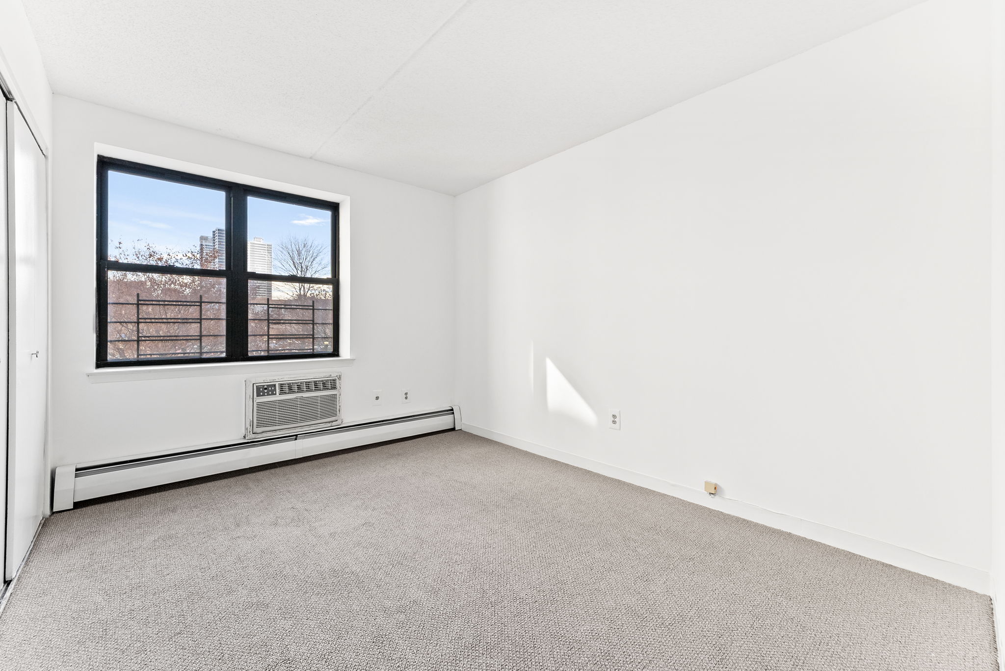 1919 Madison Avenue, Unit 214 Manhattan, NY 10035 - Photo 13 of 19 an empty room with a window