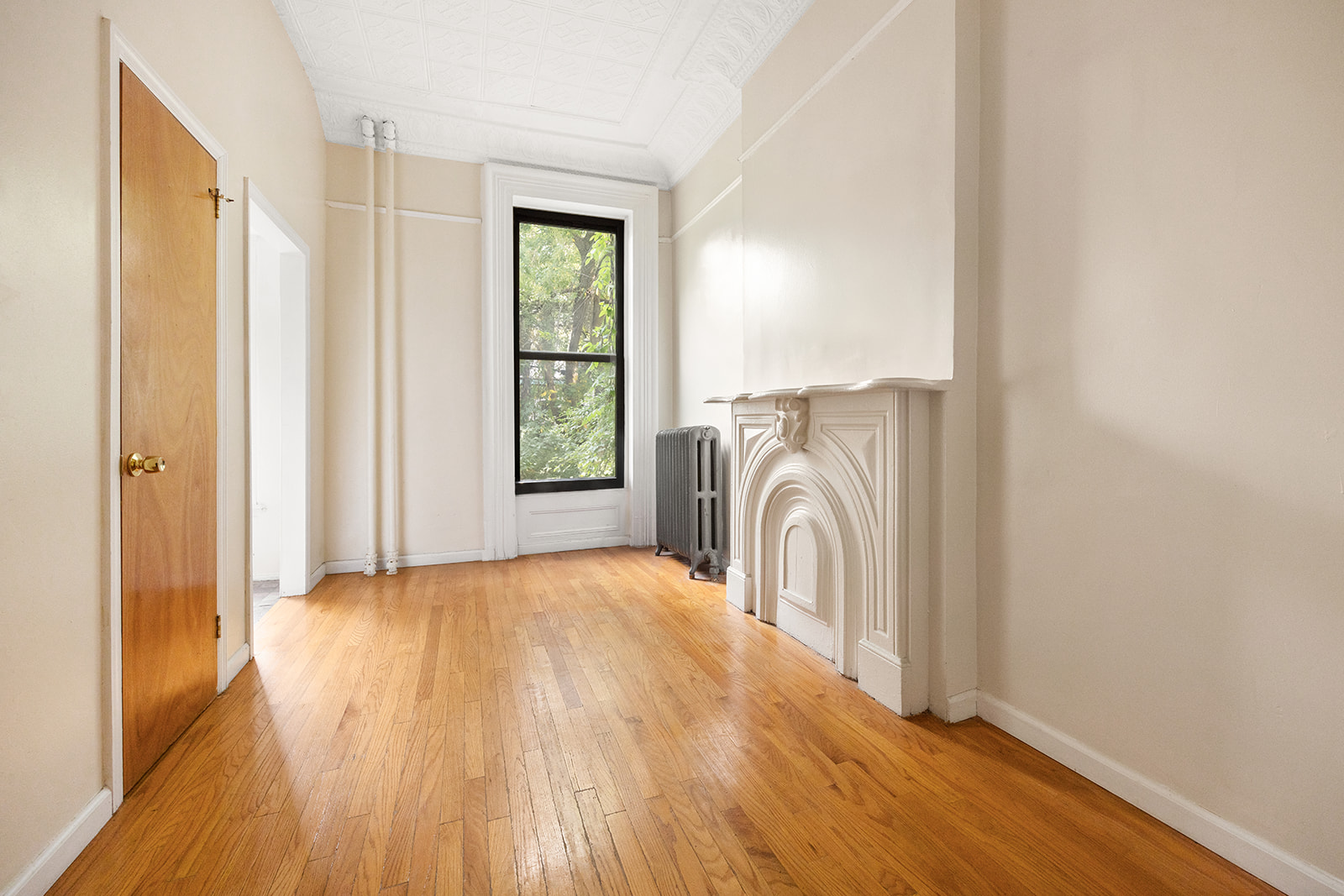 33 Park Place Brooklyn, NY 11217 - Photo 9 of 18 a view of a bedroom with wooden floor and a window