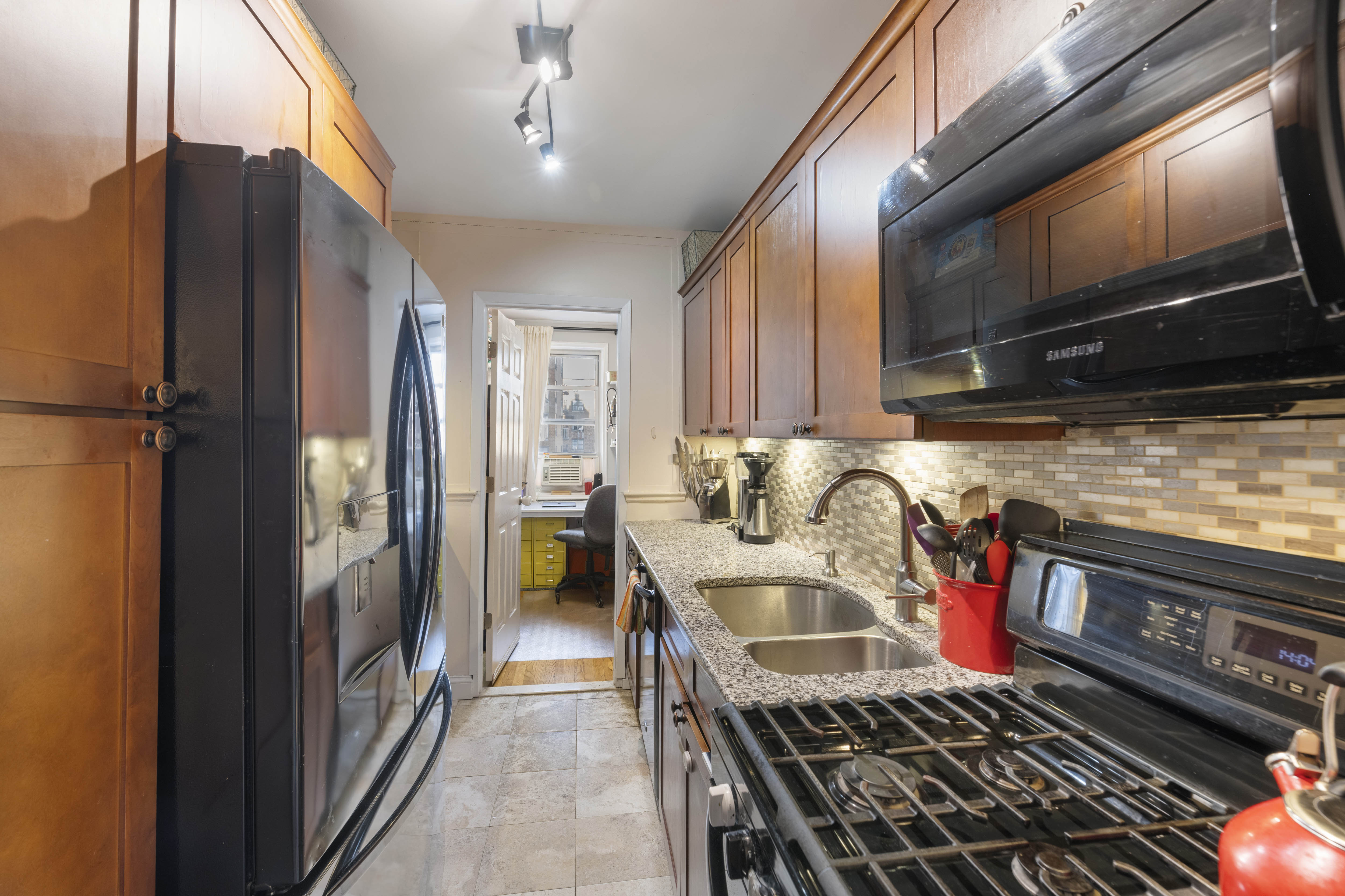3475 Greystone Avenue, Unit 7B Bronx, NY 10463 - Photo 4 of 13 a kitchen with stainless steel appliances granite countertop a refrigerator a stove and a sink