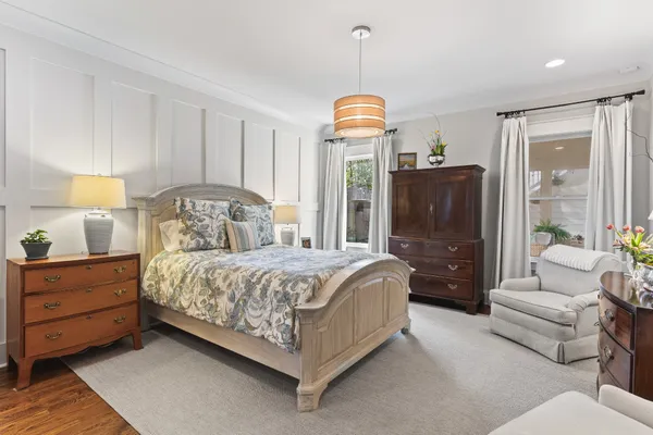 a bedroom with a bed and a chandelier