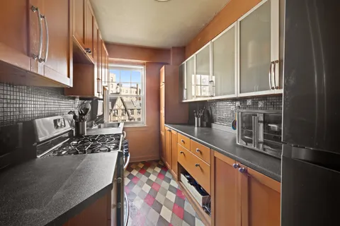 a kitchen with stainless steel appliances granite countertop a sink stove and cabinets