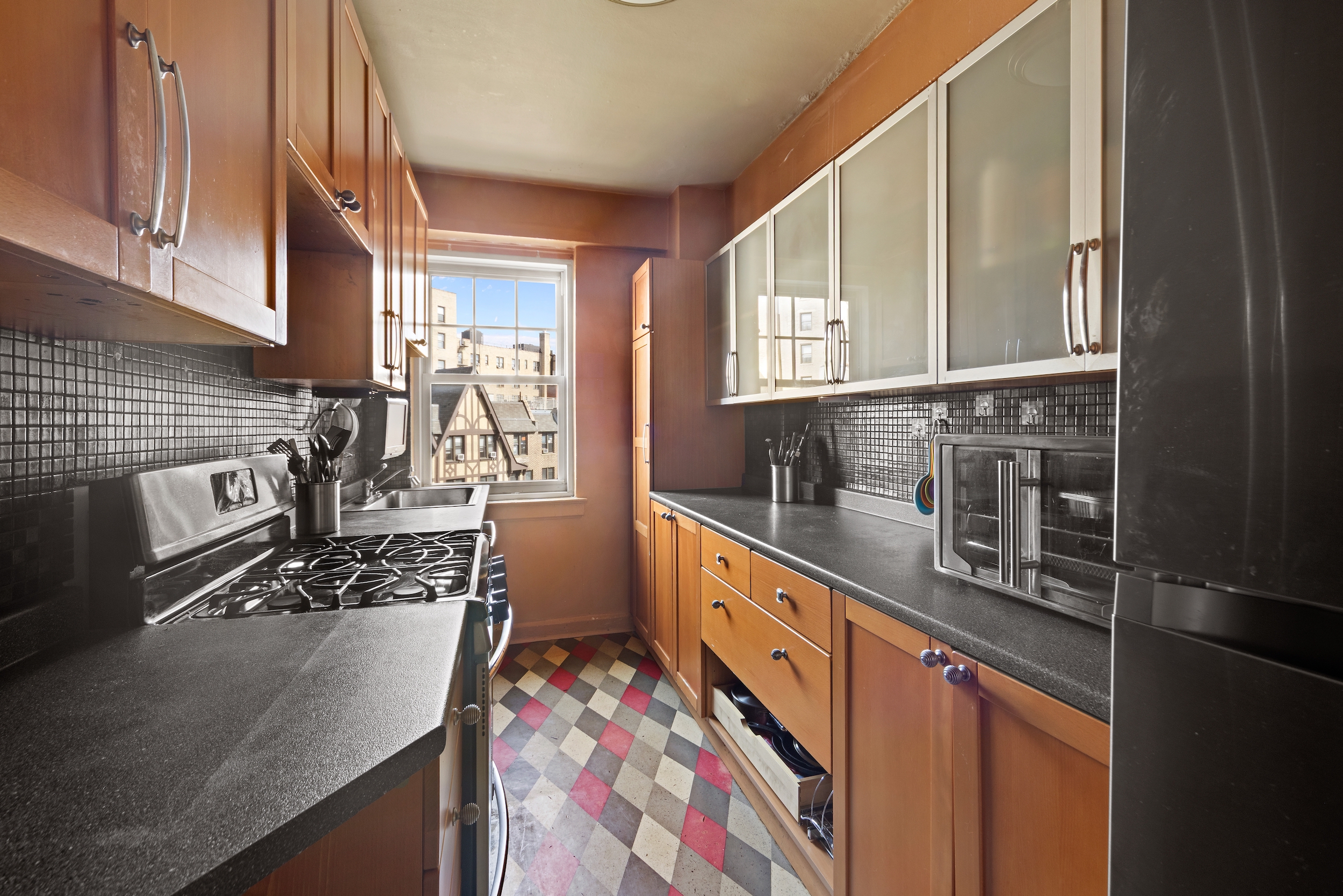 120 Cabrini Boulevard, Unit 76 Manhattan, NY 10033 - Photo 4 of 24 a kitchen with stainless steel appliances granite countertop a sink stove and cabinets