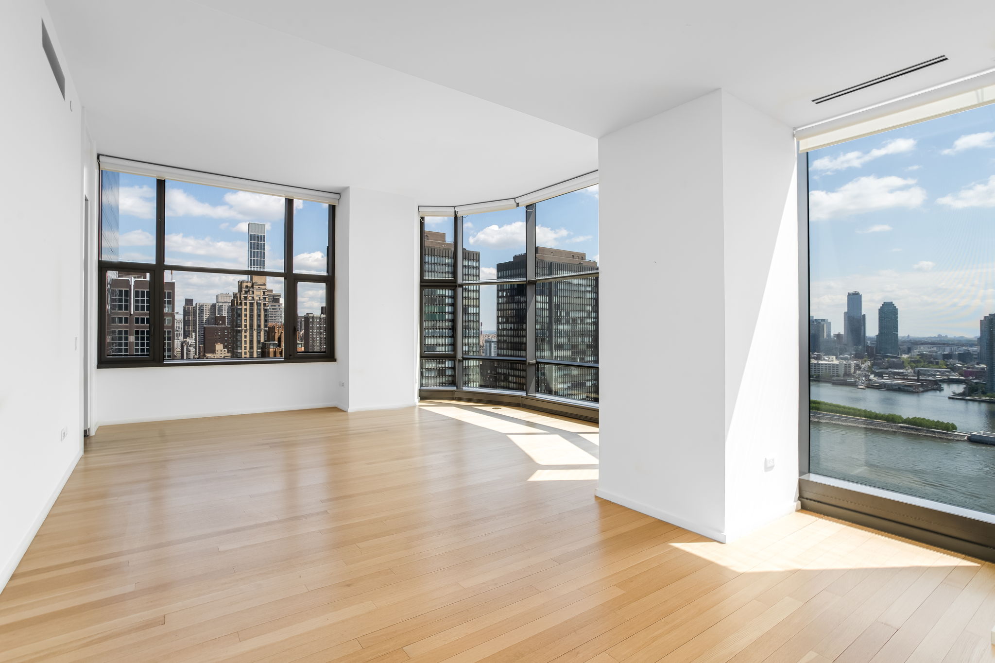 50 United Nations Plaza, Unit 26B Manhattan, NY 10017 - Photo 4 of 25 wooden floor in an empty room with a window