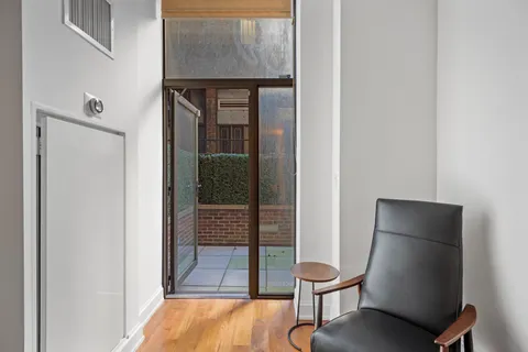 a room with a chair and potted plant